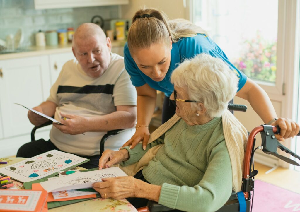 Caregiver assisting an elderly couple