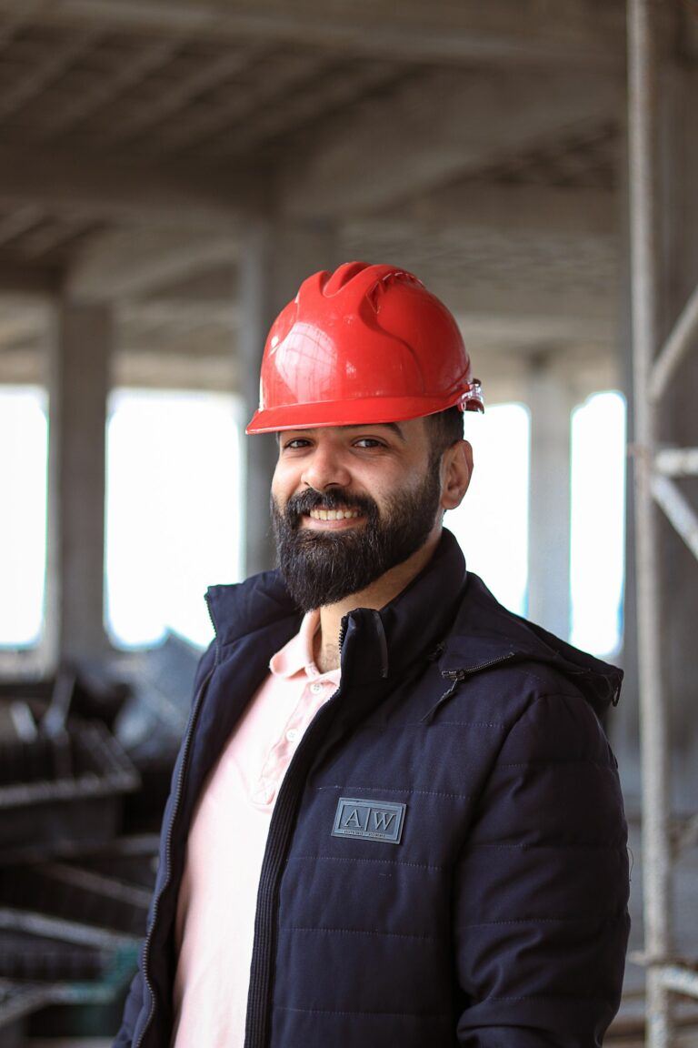 Smiling contractor in a red hard hat